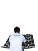 Person rolling a casaevo rug