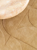 close up of hand tufted wool rug in beige