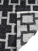 back side of a black and white woven rug