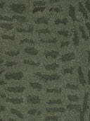 green tufted wool rug close up