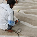 artisan working on tufted rug