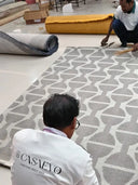 artisans working on geometric rug